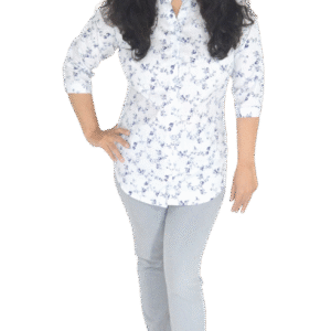 Woman wearing a white cotton shirt with blue floral print and ¾ sleeves